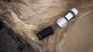 Worker balancing a load of gravel on the 83